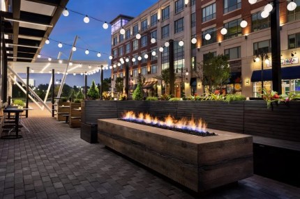 Outdoor seating area for digital content collaboration enabled by a modern solution platform at dusk.