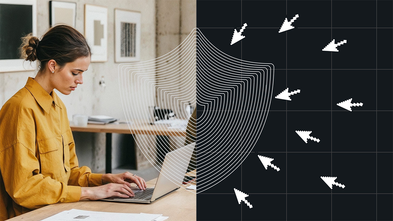 A woman in a mustard-colored shirt works on a laptop in a minimal office space. A stylized shield graphic overlays the image, dividing it in half—on the left, the woman is protected; on the right, digital arrow cursors attempt to breach the shield, symbolizing cybersecurity and protection from online threats.