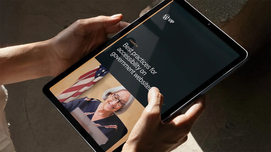 Person holding a tablet displaying a digital guide titled “Best practices for accessibility on government websites,” with an image of a smiling woman in front of an American flag.