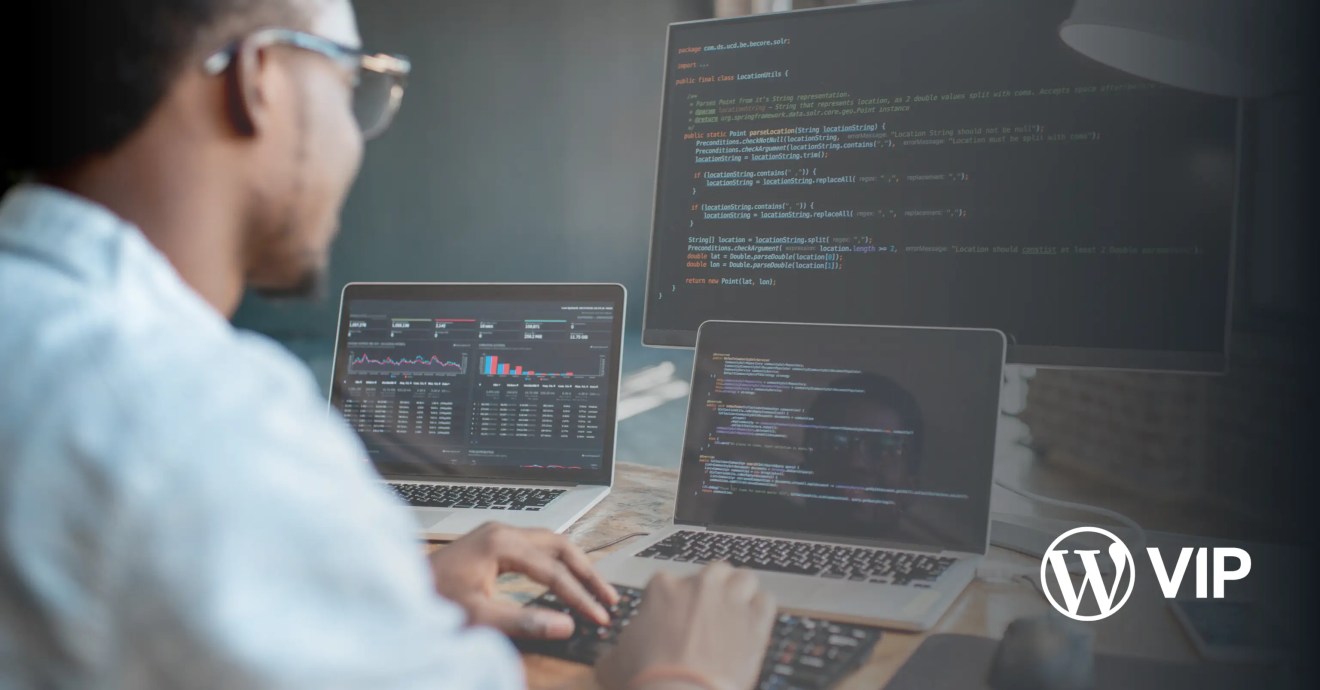 Photo of a developer looking at a cache stampede on three computer screens, related to optimizing and debugging edge caching.