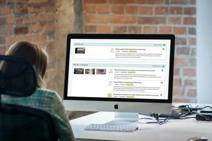Person viewing digital solution search results on a content publishing dashboard at their desk.