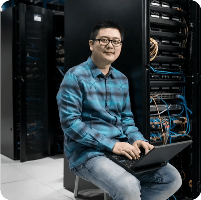Man sitting at computer, feeling confident about WordPress VIPs security and scalability.