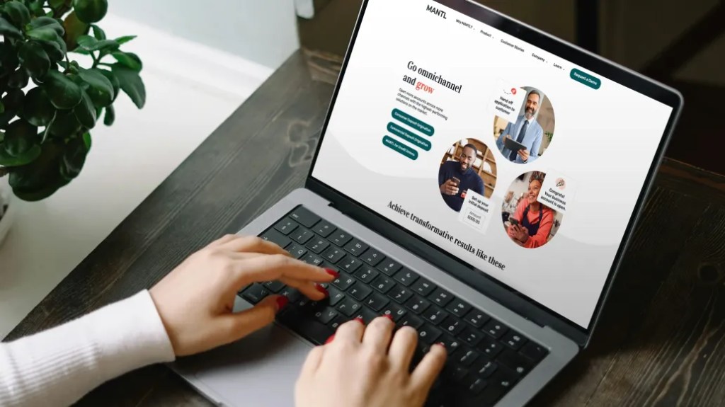 Person typing on laptop while editing website content and images in a digital solution editorial workflow.