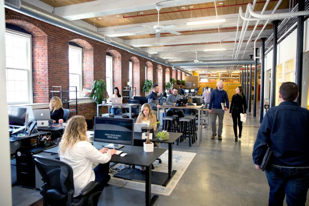 Team collaborating at desks in a digital solution office, focusing on publishing workflow and content management.