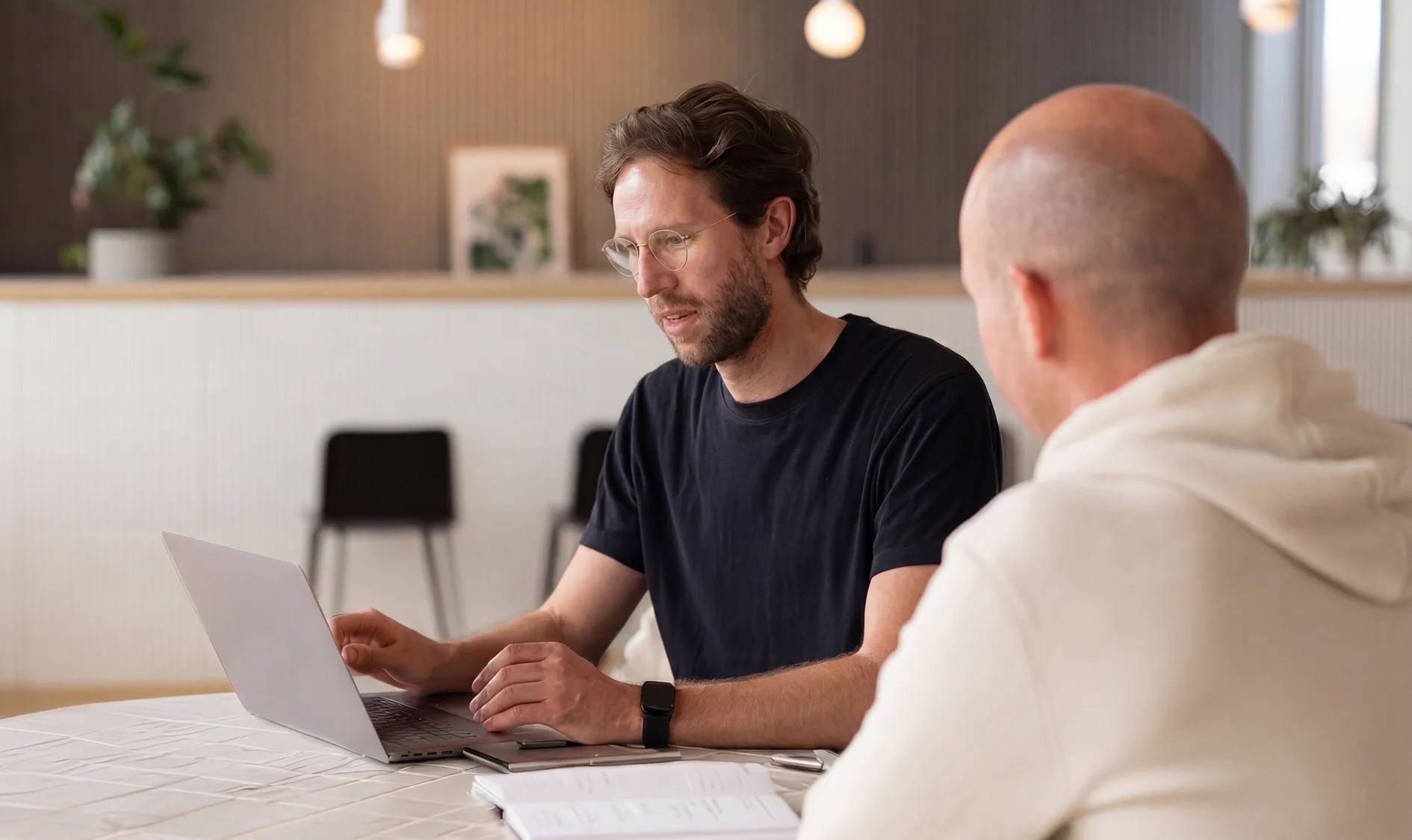 Two colleagues collaborating over a laptop during a planning session, reflecting the teamwork and expertise behind the enterprise content platform trusted by more than 1,300 organizations worldwide.