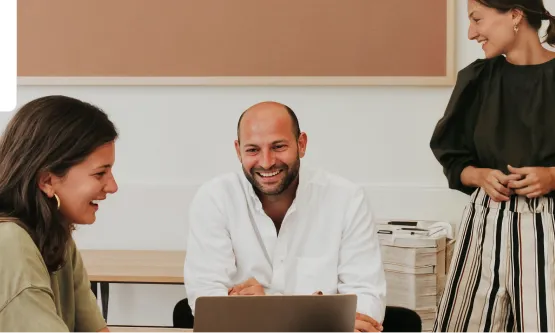 Three coworkers engaged in a collaborative work session.