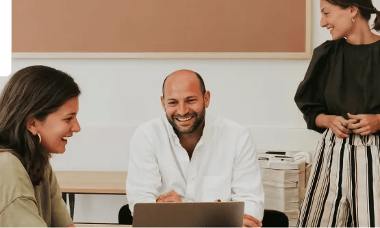 Three coworkers engaged in a collaborative work session.