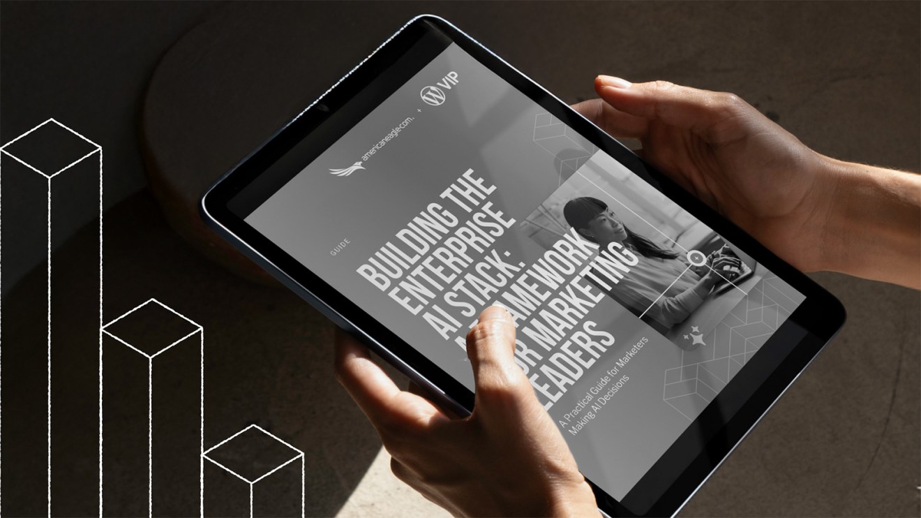 Hands holding a tablet displaying an eBook titled Building the Enterprise AI Stack for Marketing Leaders, offering actionable insights on enterprise AI implementation.