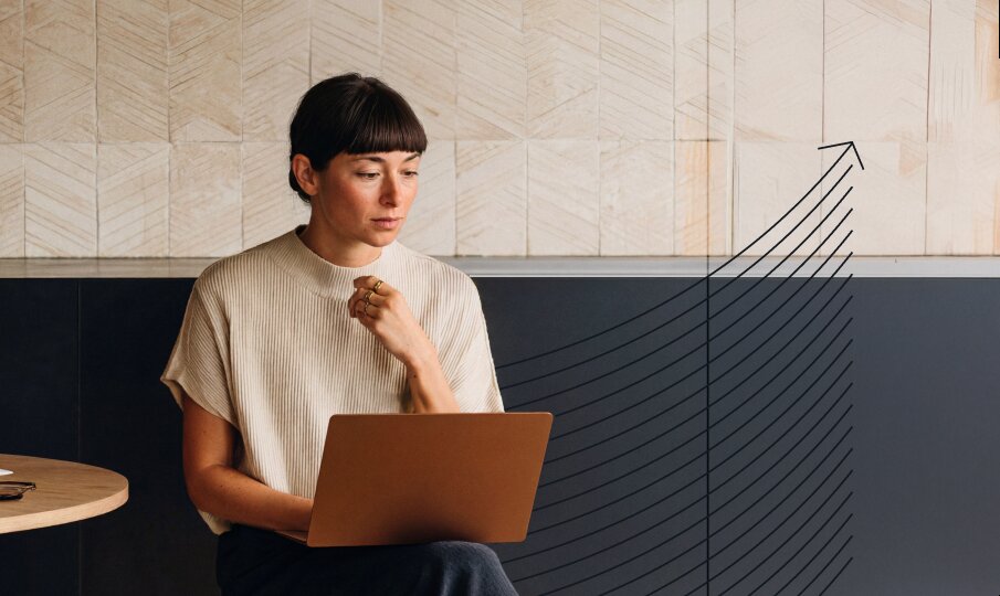 Person working on a laptop with an upward growth graphic overlay, representing content performance, scalability, and continuous optimization across WordPress VIP capabilities.
