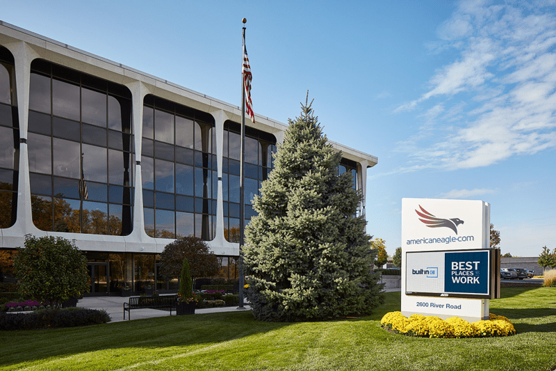 The front of the American Eagle.com building featuring the green, and building sign which includes the text "americaneagle.com, built in Chi, Best places to work."