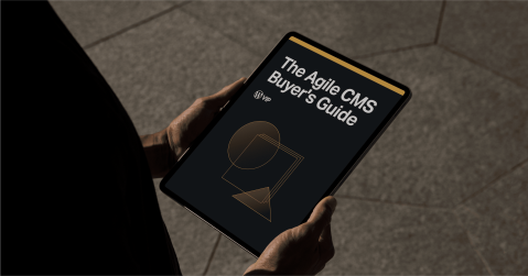 Person holding tablet showing The Agile CMS Buyers Guide digital solution content overview.