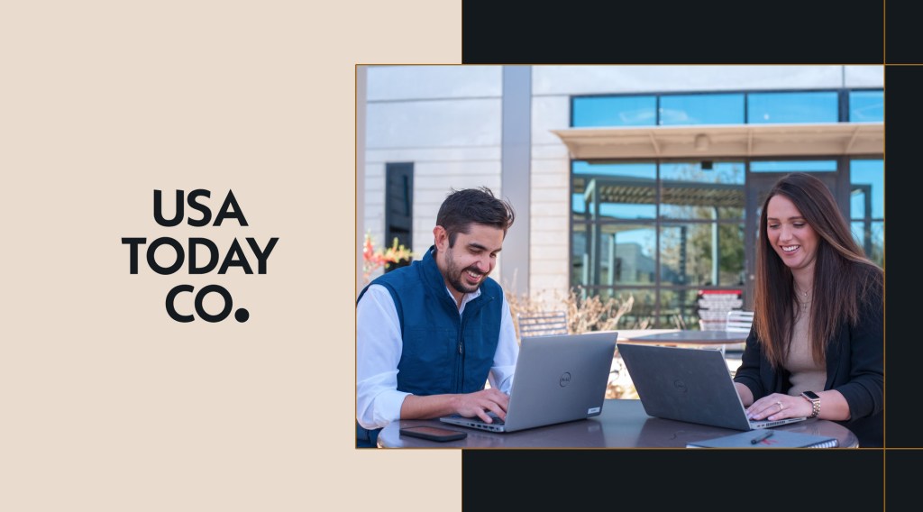 Two people working on laptops outside, next to the USA Today Co. logo