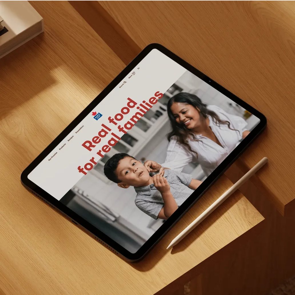 Tablet showing a website with a mother and son in a kitchen and the headline “Real food for real families”.