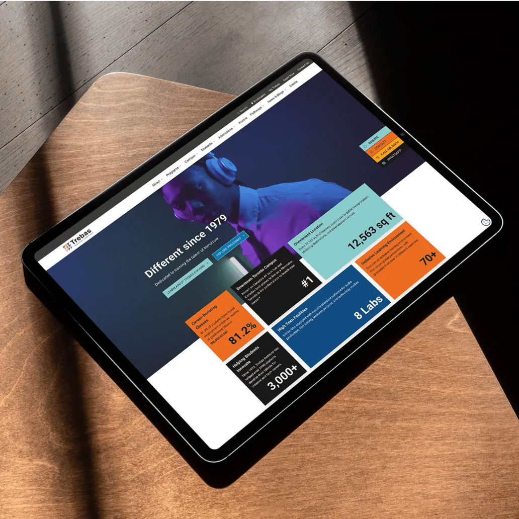 Tablet displaying Trebas Institute's homepage with vibrant infographics and the headline “Different since 1979.”