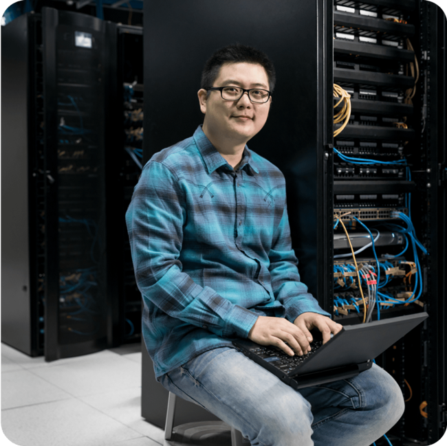 Man sitting at computer, feeling confident about WordPress VIPs security and scalability.