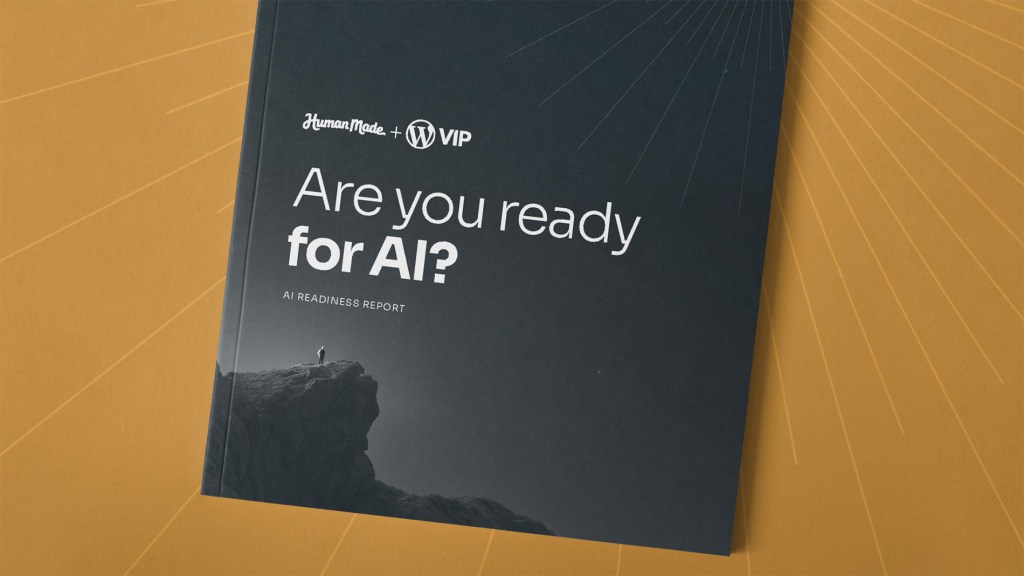 A printed report titled “Are you ready for AI? — AI Readiness Report” co-branded by Human Made and WordPress VIP, placed on a wooden grid surface. The dark cover features a minimalist mountain silhouette with a small figure standing on a peak, giving a sense of scale and exploration.