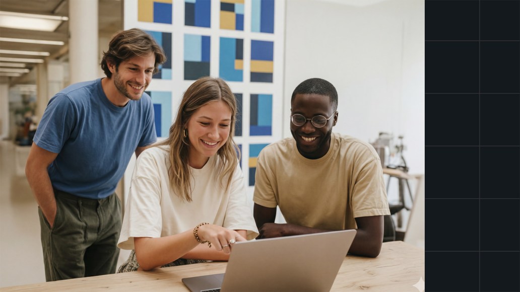 Product team collaborating around a laptop in a modern workspace, representing how a CMS helps organizations meet the future of digital content.
